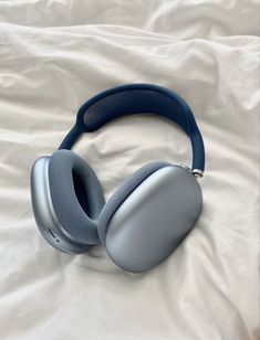 a pair of headphones sitting on top of a bed