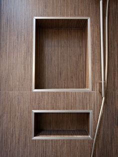 a bathroom with a shower head and wooden walls