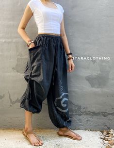 The harem style trousers made from cotton fabric 100%with an elasticated smock waist and ankles they provide a comfortable lightweight fit, perfect for casual wear, festivals, yoga, holidays as well as pairing with a plain top to get that popular look.   Materials: Cotton Sizing: One size fits most. Size : (inches) ✿Waist : 22-42 inch ( 55-106 cm ) ✿ Hip :up to 49 inch ( 124 cm) ✿ Length 39" ( 100 cm ) ✿2 sides pockets S I Z E : US SIZE 4 - 12 , UK SIZE 8 - 16 , EU SIZE 36 - 44 MODEL SIZE : size Casual Spring Harem Parachute Pants, Casual Harem Pants For Festivals, Casual Festival Harem Pants, Casual Summer Harem Parachute Pants, Summer Cotton Harem Pants With Loosely Fitted Hips, Baggy Cotton Ankle-length Bottoms, Black Harem Pants For Spring Festival, Black Cotton Harem Yoga Pants, Black Cotton Harem Pants For Yoga