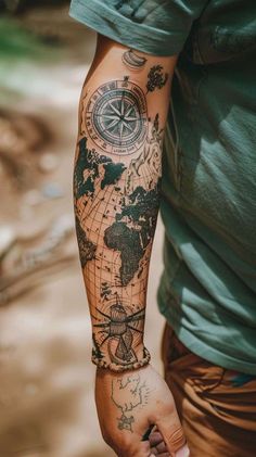 a man's arm with a map tattoo on it and a compass in the middle