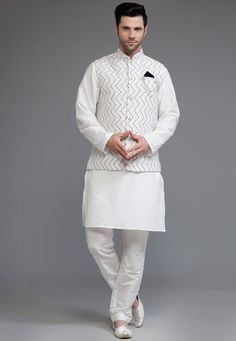 Cotton Silk Kurta with a Cotton Silk Pant in Off White Color. Available with a Cotton Silk Nehru Jacket in Off White color. This Chinese Collar Neck and Half Sleeve Ready-made attire is Enhanced with Buttons and Digital Printed Chevron Pattern.   Do note: Brooch and Footwear shown in the image is for presentation purposes only. Half to one inch may vary in measurement. (Slight variation in actual color vs. image is possible) We Sell all kinds of Menswear. Mens Kurta | Mens Kurta & Pant | Traditi Traditional White Sets For Workwear, White Nehru Jacket With Stand Collar For Formal Occasions, Traditional White Sets With Stand Collar, White Nehru Jacket With Stand Collar For Festive Occasions, White Bandhgala With Stand Collar For Festive Occasions, White Festive Nehru Jacket With Stand Collar, Festive White Bandhgala With Stand Collar, White Nehru Jacket For Winter Formal Events, Festive White Nehru Jacket With Stand Collar