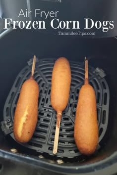 three frozen corn dogs on a stick in an air fryer