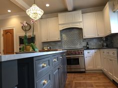 a kitchen with white cabinets and wood floors is pictured in this image from the front view