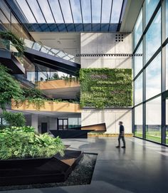 a man is walking in front of a building with plants growing on the side of it