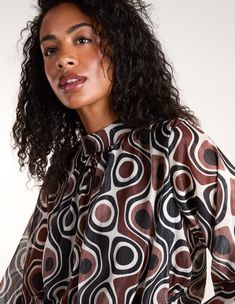 Looking to add more print into your life? Say 'hi' to this high neck geometric print blouse, the perfect style to add to your AW collection. Outside: 100% Polyester Inside: 95% Viscose 5% Elastane Made in Italy Machine washableHigh neckLong cuff sleeveButton neck Model wears a size S/M Model height: 5ft 11 / 180cm Chic Brown Printed Tops, Patterned Retro Print Blouse, Fall Retro Print Patterned Blouse, Chic Long Sleeve Blouse With Geometric Pattern, Chic Workwear Blouse With Geometric Pattern, Chic Multicolor Blouse With Geometric Pattern, Chic Patterned Tops With Abstract Print, Spring Black Blouse With Geometric Pattern, Retro Black Blouse For Fall