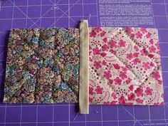 two pieces of fabric sitting on top of a cutting board