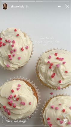 four cupcakes with white frosting and pink sprinkles on them