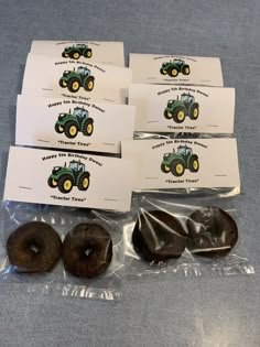 four donuts in plastic wrappers sitting next to each other