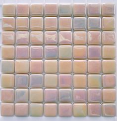 a white and pink tile wall with square tiles