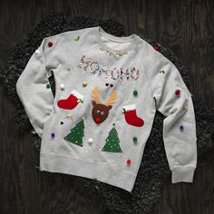 a white sweater with christmas decorations on it