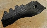 a piece of wood that has been carved into the shape of an alligator's head