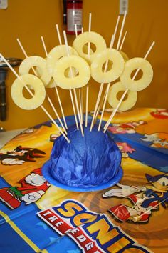 there are some donuts on top of a blue cake with toothpicks sticking out of it