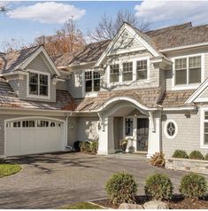 a large house with two car garages in the driveway