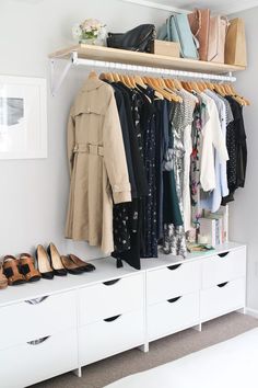 an organized closet with clothes and shoes