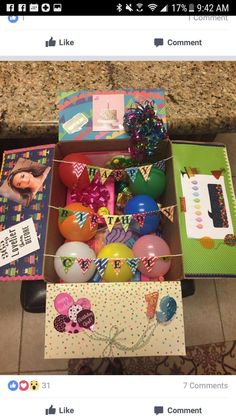 an open box filled with lots of different items on top of a counter next to a table