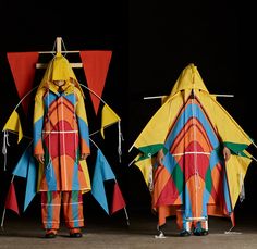 two people wearing colorful clothes made out of kites