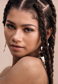 a beautiful young woman with long braids on her head