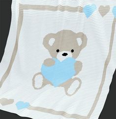 a crocheted baby blanket with a teddy bear holding a blue heart on it