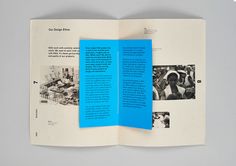 an open book with blue pages and pictures on it, sitting on top of a table