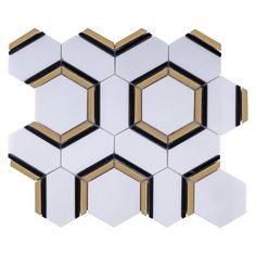 the white and gold hexagonal tiles are arranged in an intricate pattern, with black accents