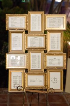 a bunch of framed pictures on a stand with names and dates in them for seating