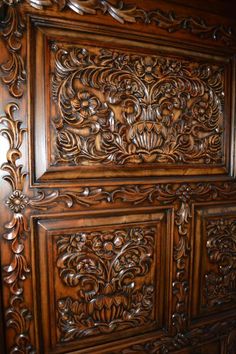 an ornate carved wooden door with intricate carvings