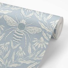 a blue and white wallpaper with a bee on it