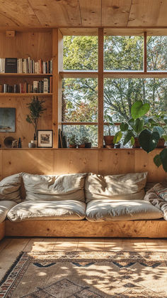 a living room filled with lots of furniture next to a large window covered in books