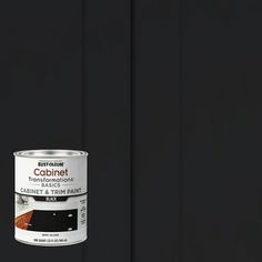 a can of black paint sitting on top of a table