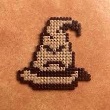 an old school computer game character made out of perler beads on a brown surface