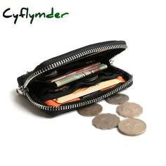 an open zippered wallet with coins and pens in it on a white surface,