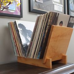 there are many records on the shelf in this room and one is stacked with them