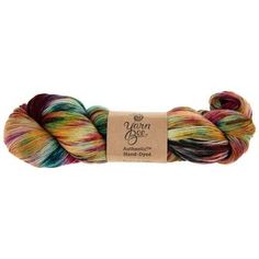 a skein of yarn with multicolored stripes on the end and a brown tag