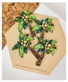 two green palm trees with pearls on them