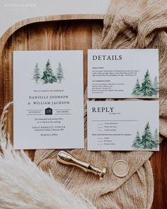 the wedding stationery is laid out on top of a wooden tray with furnishing