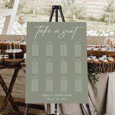 a table with cupcakes and an easel for seating