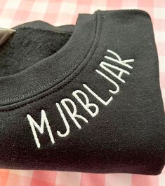 a close up of a black shirt with the word mr and mrs printed on it