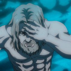 a man with long hair and no shirt in the water holding his hands to his face