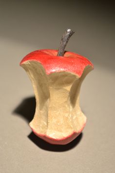 an apple that has been carved to look like it is in the shape of a vase