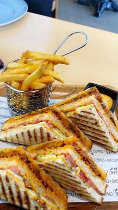 several sandwiches and french fries on a table