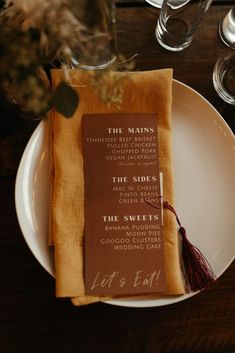 a table setting with wine glasses and napkins