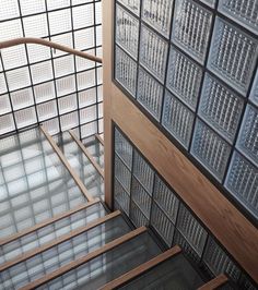 an open door with glass blocks on the wall and wooden handrails in front of it