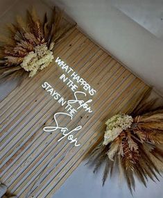 two dried flowers sitting on top of a bamboo mat that says whatever is in the air