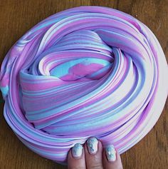 there is a purple and blue swirled cake on the table