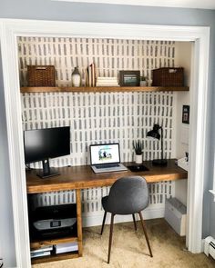 a computer desk with a laptop on top of it in front of a book shelf