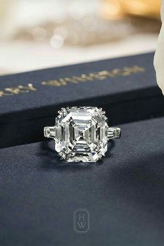 an engagement ring sitting on top of a book with a diamond in it's center