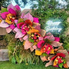 the birthday sign is decorated with colorful flowers