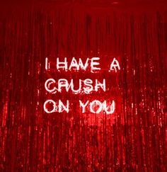 the words i have a crush on you are written in white ink on a red background