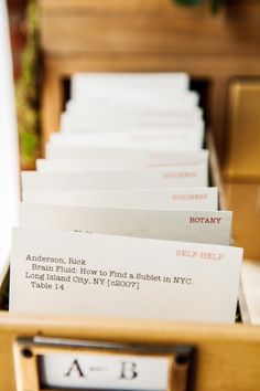 several mail envelopes are in a wooden box