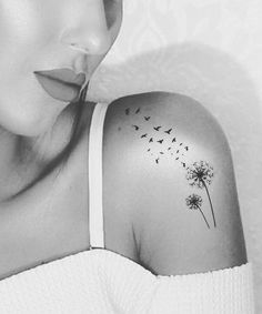 a woman with a dandelion tattoo on her shoulder